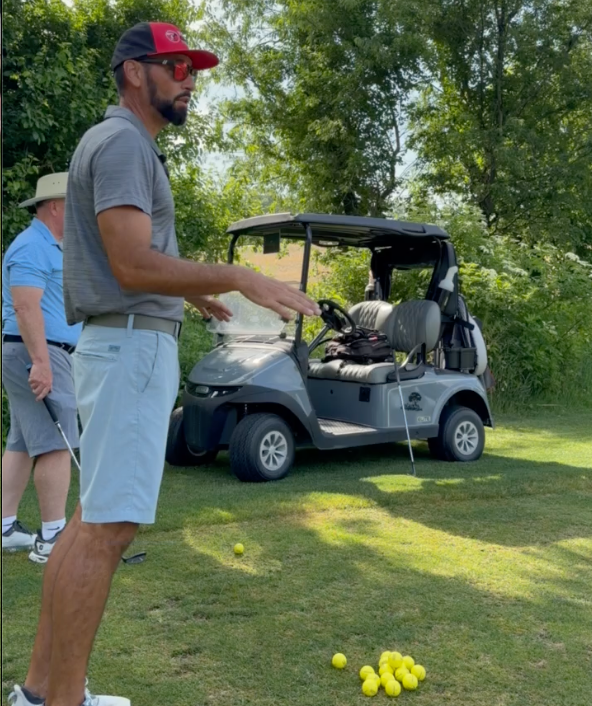 TGT coach demonstrating a golf movement
