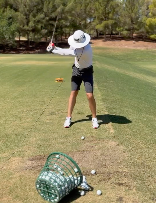 Student practicing a guided swing drill