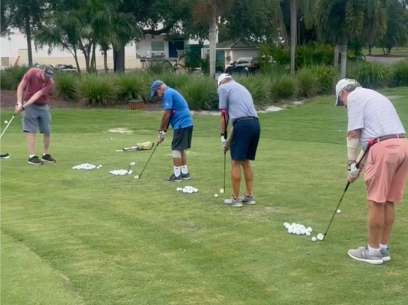 Golf school students practicing together on the range