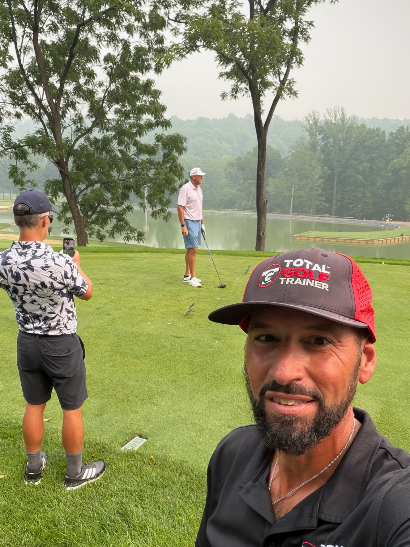 TGT coach filming instruction on the golf course
